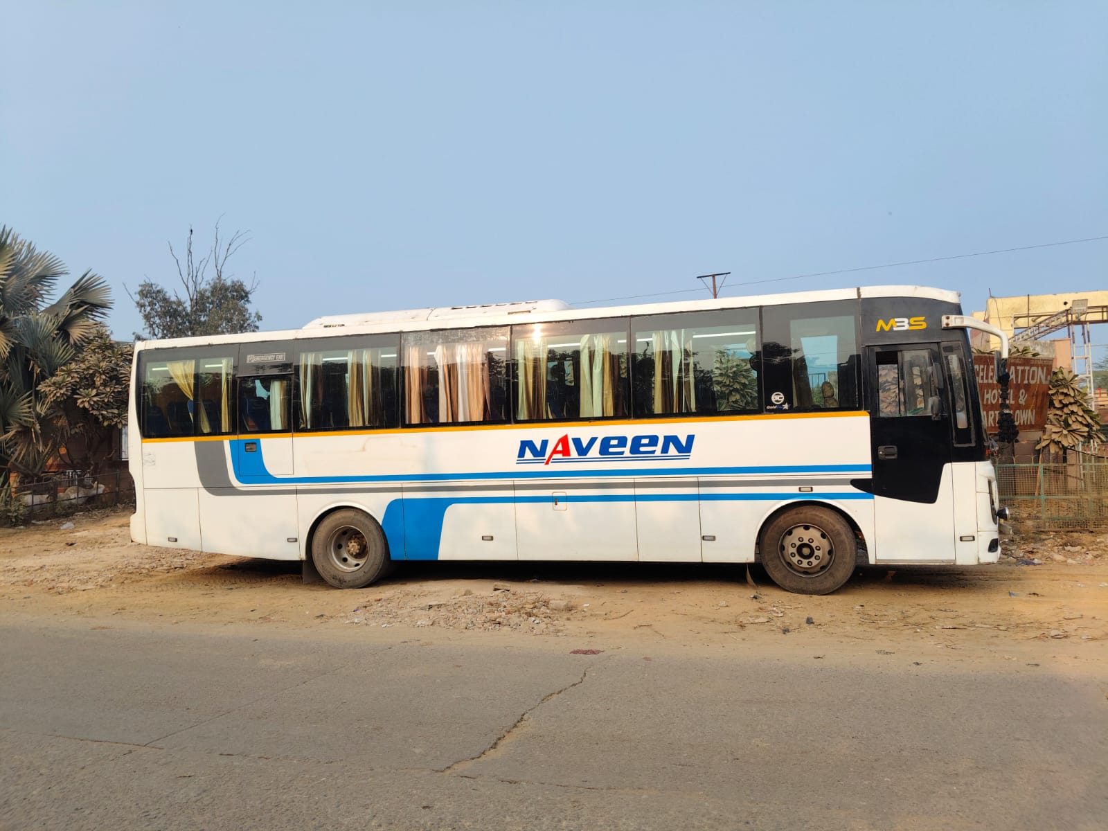 Full side profile of the white and blue coach